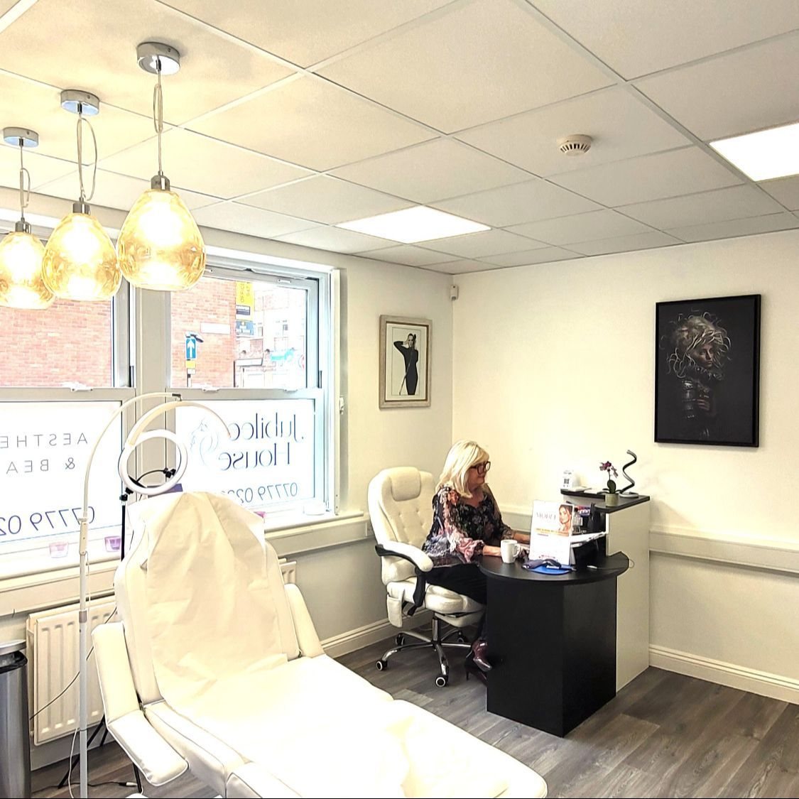The treatment room at Jubilee House, with Mandy Drake at her desk beneath amber glass lamps