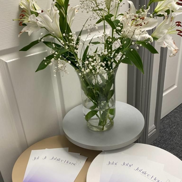 White lilies in the clinic beside Jubilee House appointment cards